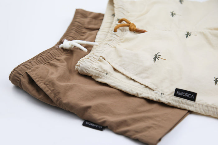 Close-up of quick-dry recycled polyester fabric – mocha swim trunks