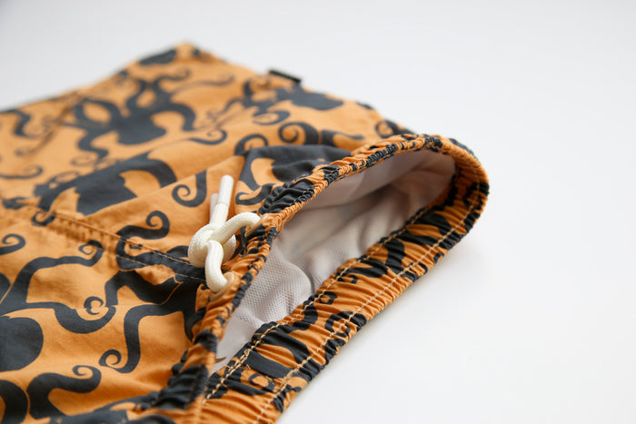 Elastic waistband detail on octopus desert sand boys swim trunks