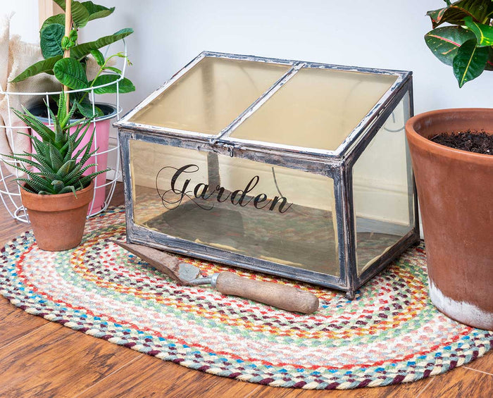 Multi Colored braided rug under a garden box in spring garden shed