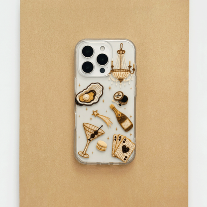 A clear phone case decorated with macron-style graphics of oysters, a cocktail, a champagne bottle, playing cards, and a macaron.