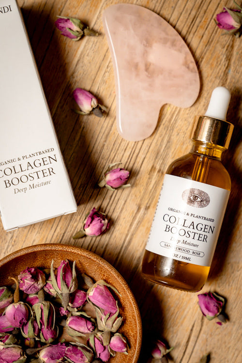 Collagen booster product with dried roses and a wooden tool on a wooden surface