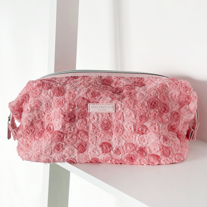 Pink Coconut Lane expandable makeup bag with a floral print sitting on a white shelf.