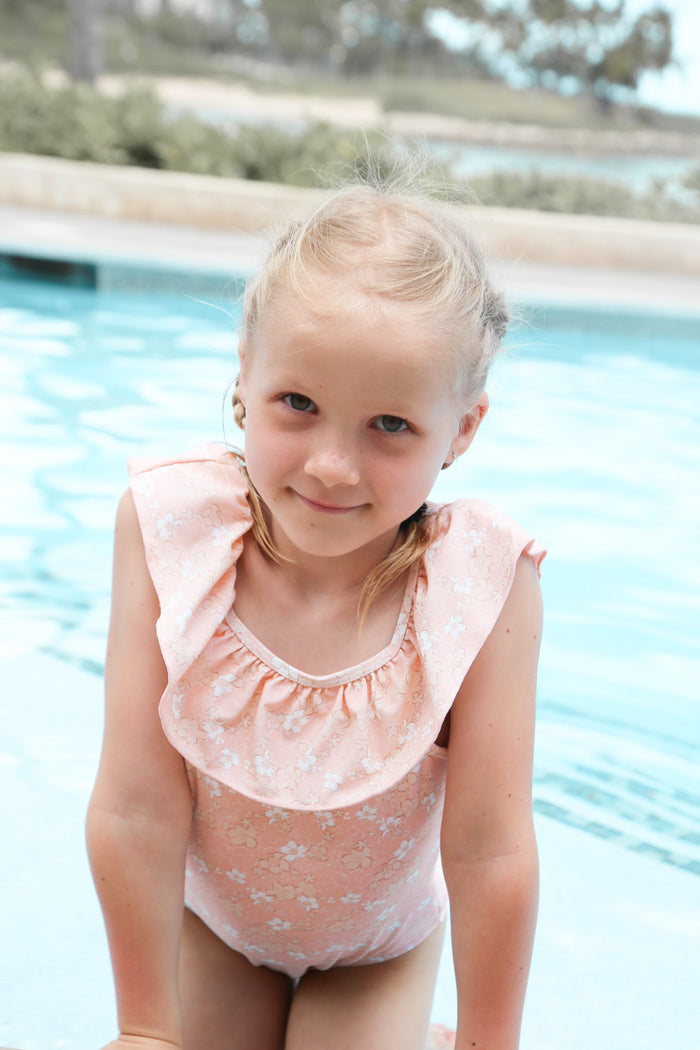 Girl wearing Evangelina Tuscany ruffle swimsuit – side view with adjustable straps
