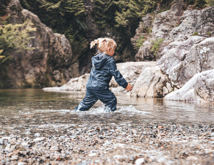 Child wearing navy hard-shell rain jacket – side view