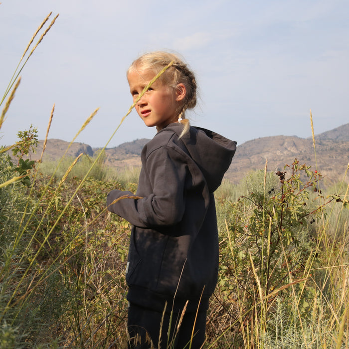 Child wearing lava brushed terry hoodie – side view with hood