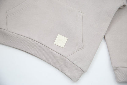 Kangaroo pocket and rib cuff detail on dove brushed terry kids hoodie