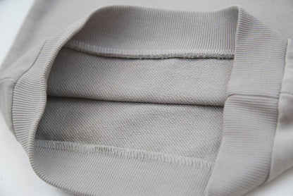 Close-up of soft organic french terry fabric texture – pebble grey kids hoodie