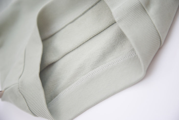 Close-up of organic french terry fabric texture – sage kids shorts