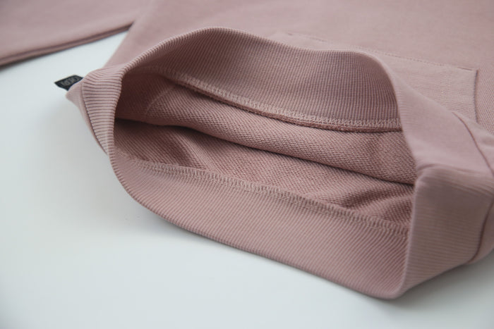 Close-up of organic french terry fabric texture – mauve kids sweatpants
