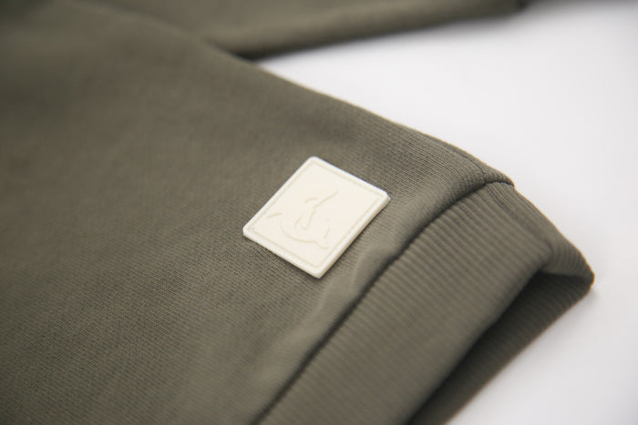 Rib cuff and hem detail on dusty olive french terry kids sweatshirt