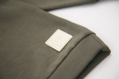 Rib cuff and hem detail on dusty olive french terry kids sweatshirt