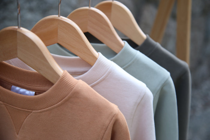 Close-up of french terry fabric and crewneck on oat kids sweatshirt