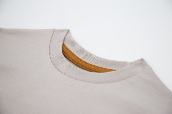 Close-up of organic cotton fabric and crew neckline – dove kids tee