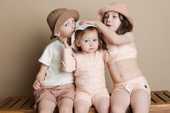 Baby wearing Evangelina Tuscany jumpsuit – side view with high collar