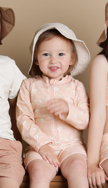 Baby wearing Evangelina Tuscany jumpsuit – side view with high collar