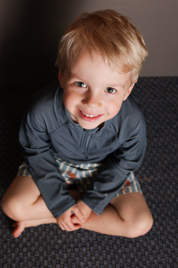Boy playing in Fjord rashguard by KidORCA