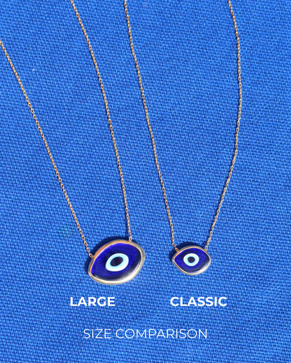 Size comparison of two dark blue Murano glass evil eye necklaces, one large and one small