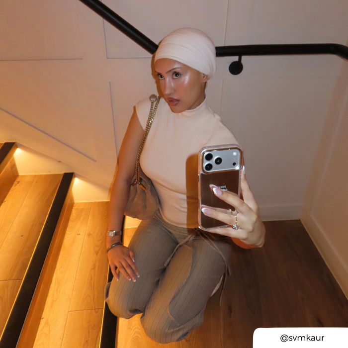 Woman taking a selfie, holding a Mirror phone case, with the text "It's not that deep" printed on the back in small font.