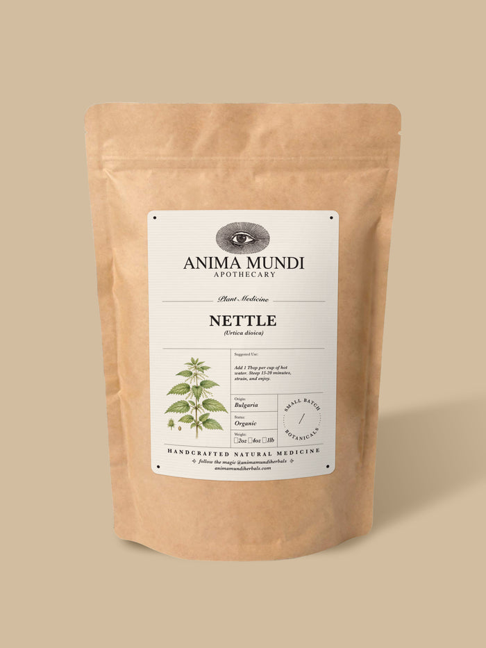 A kraft paper stand-up pouch of Anima Mundi Apothecary Nettle herbal medicine, shown on a solid beige background.