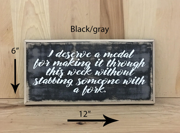 12x6 black/gray funny wood sign with white lettering.