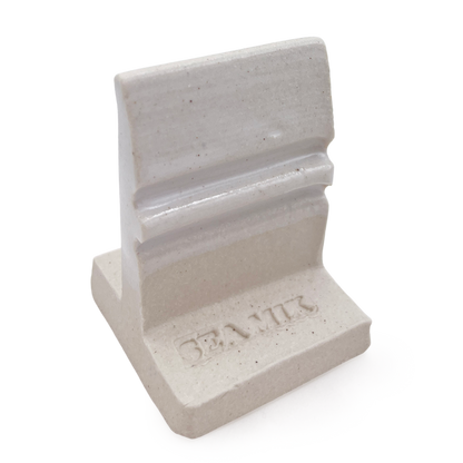 SP32 White Satin glaze on an L-shaped test tile, glossy white on the grooved upright above a bare speckled clay base