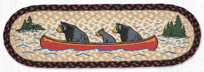 Stair tread with black bears in a red canoe on a lake
