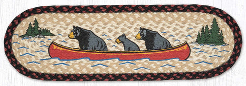 Stair tread with black bears in a red canoe on a lake