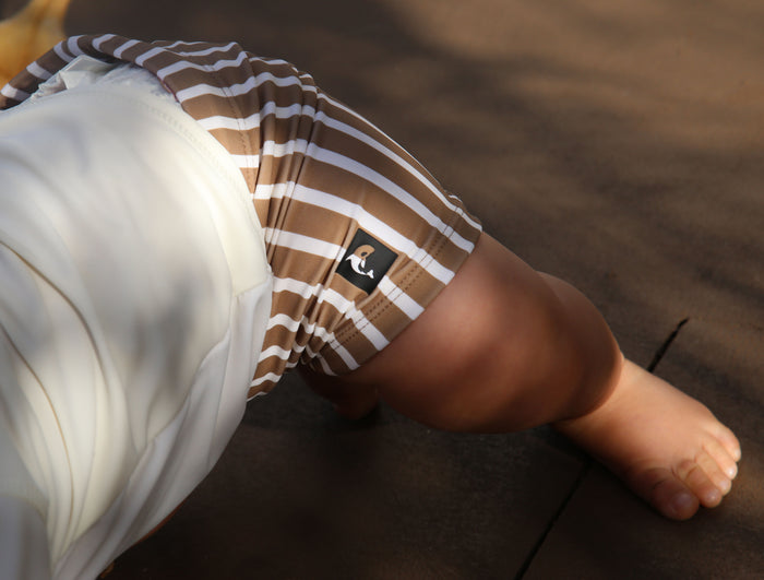 Kid playing in stripe khaki swim boardie shorts by KidORCA