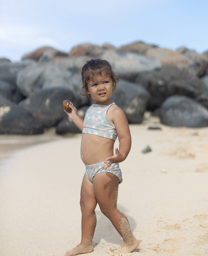 Girl wearing Evangelina sage swim top – side view with adjustable straps