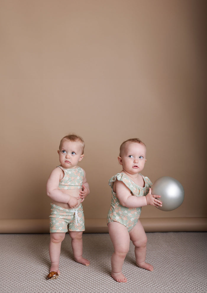 Girl playing in Evangelina sage swim top by KidORCA