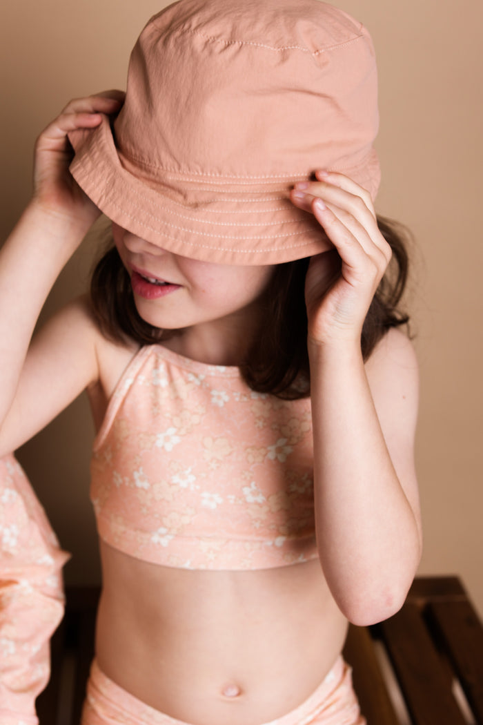 Girl playing in Evangelina Tuscany swim top by KidORCA