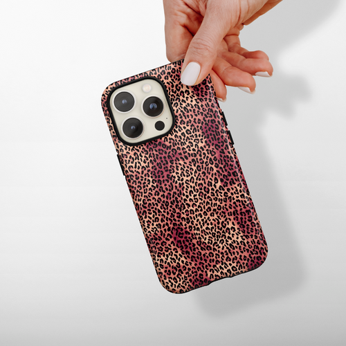 Hand holding a pink and brown leopard print Coconut Lane Tough Phone Case against a white background.