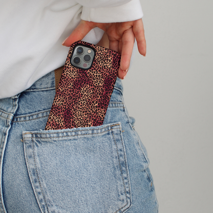 Leopard print Coconut Lane phone case partially tucked into the back pocket of light blue jeans.